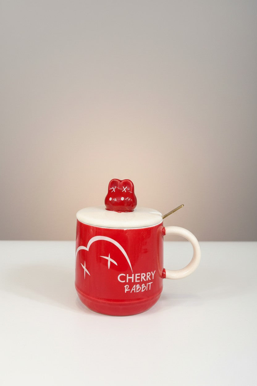 Asoula red porcelain mug with white heart and text "CHERRY RABBIT", cream lid with cute rabbit topper and gold spoon.