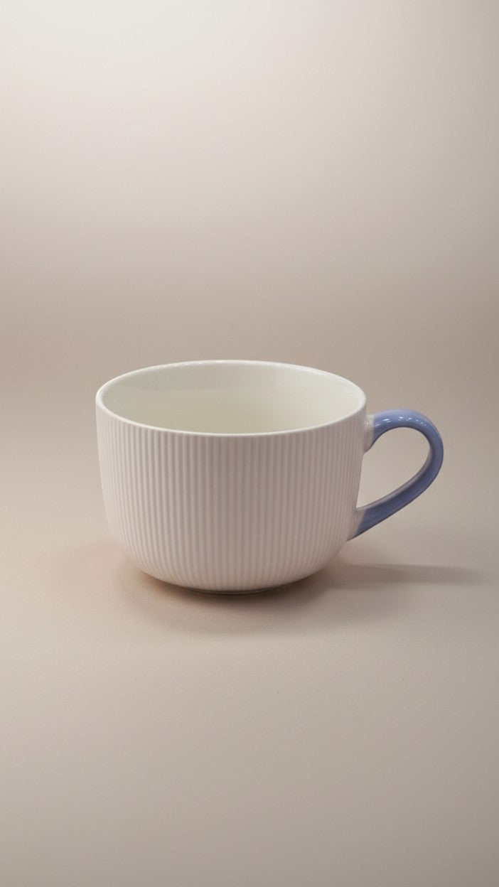 Asoula white ribbed ceramic soup mug with a light blue handle, perfect for cozy meals.