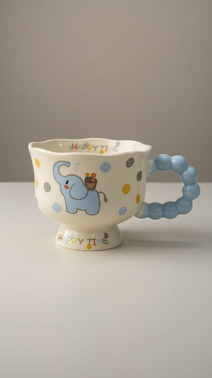 Asoula ceramic mug with a cute blue elephant design and a playful bubble handle. Features polka dots and