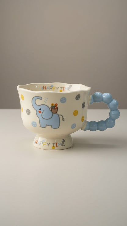 Asoula ceramic mug with a cute blue elephant design and a playful bubble handle. Features polka dots and
