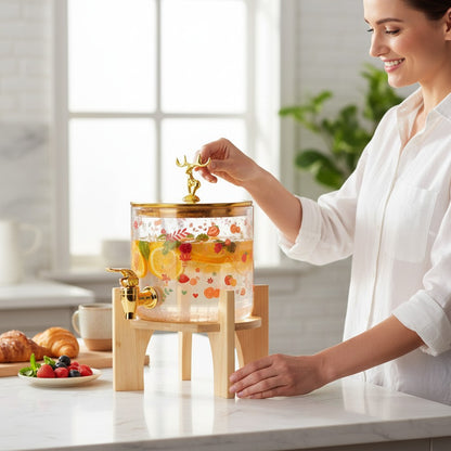 Asoula 5L glass beverage dispenser with gold deer lid and floral fruit design, includes wooden stand and gold spigot.