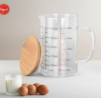 Asoula heat-resistant borosilicate glass measuring cup with bamboo lid, 500ml capacity, ideal for liquids and baking ingredients.
