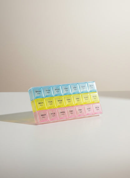 Asoula 7-day weekly pill organizer with 28 compartments in blue, yellow, and pink. Each day has 4 sections: morning, noon, night, and backup.