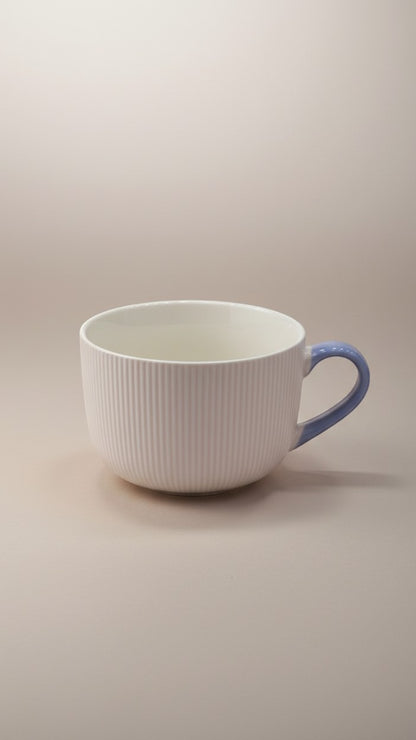 Asoula white ribbed ceramic soup mug with a light blue handle, perfect for cozy meals.